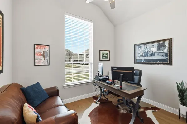 a living room with furniture a rug and a window