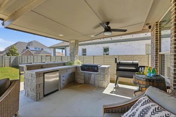 a kitchen with a sink appliances cabinets and furniture