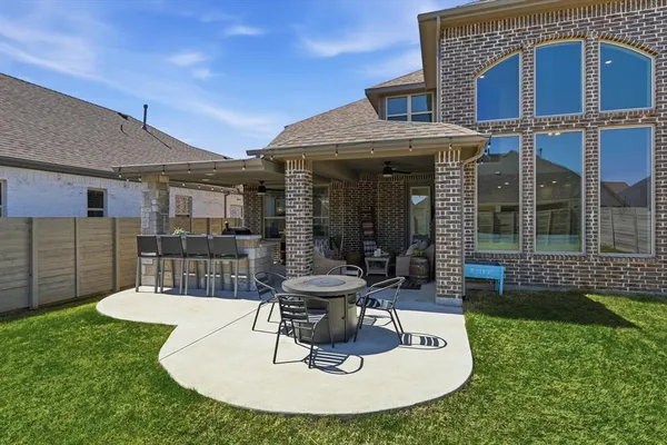 a view of a house with backyard porch and sitting area
