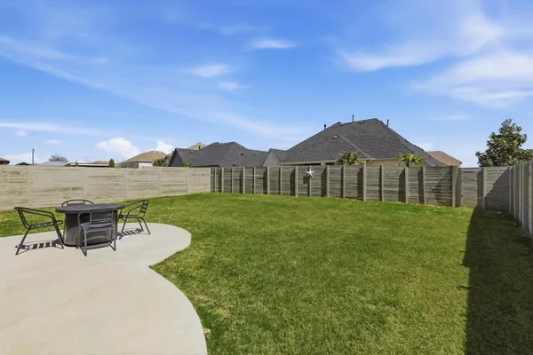 a view of a house with a yard and table