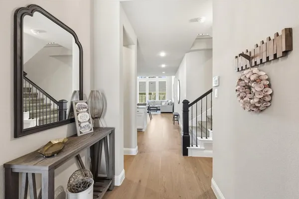 a view of entryway and hall with wooden floor