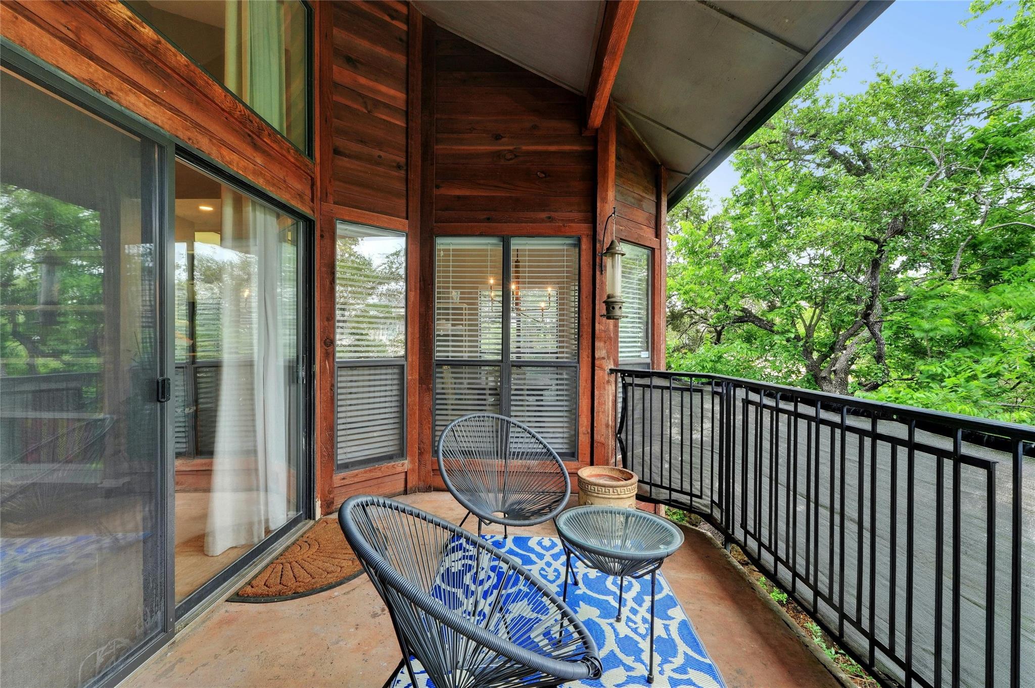 4711 Spicewood Springs Road, Unit 1201 Austin, TX 78759 - Photo 14 of 35 Covered patio with a peaceful tree-lined backdrop