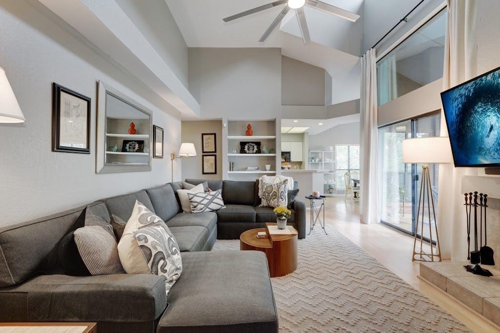4711 Spicewood Springs Road, Unit 1201 Austin, TX 78759 - Photo 2 of 35 Open living area with natural light from the wall of windows
