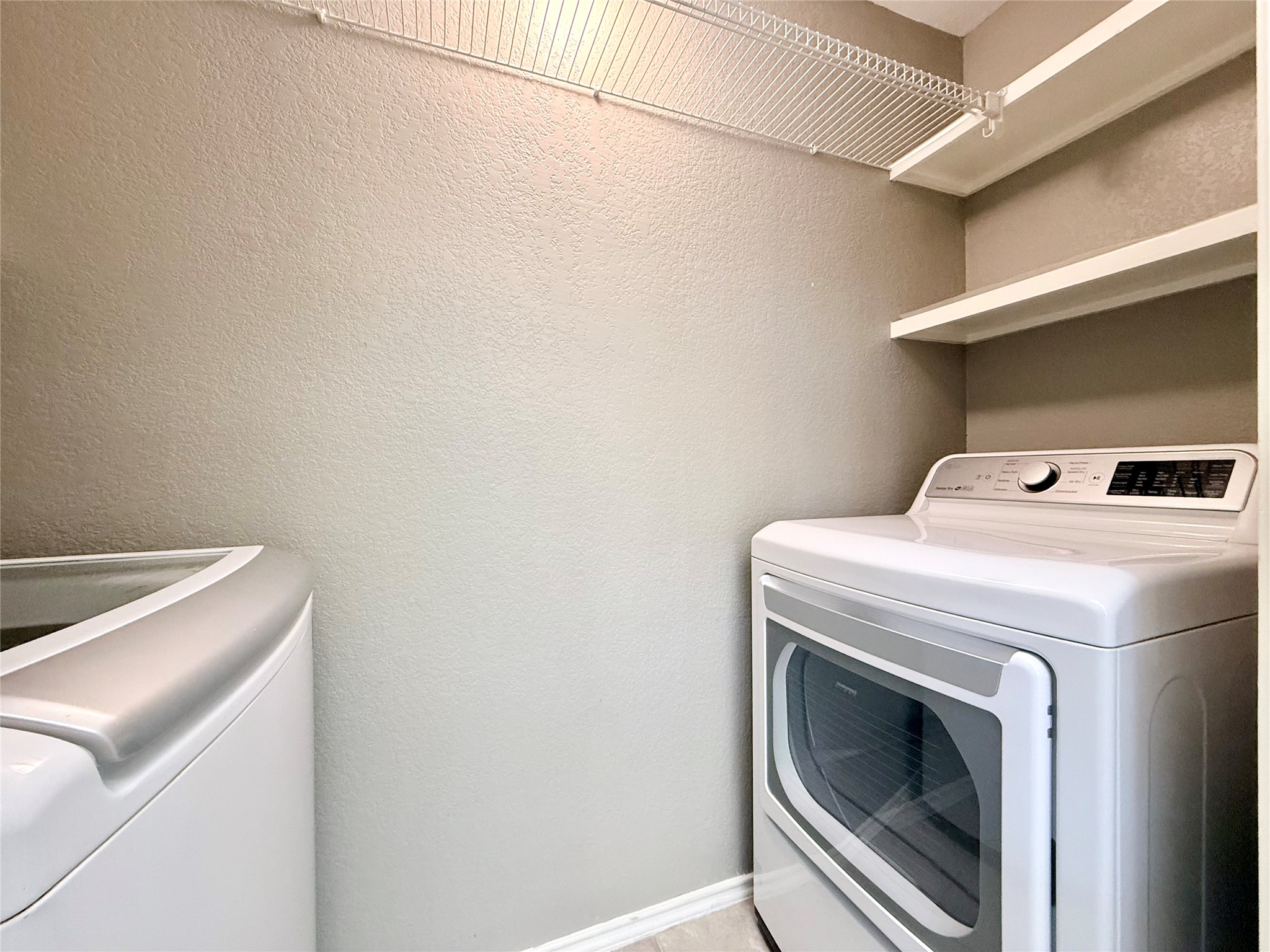4711 Spicewood Springs Road, Unit 1201 Austin, TX 78759 - Photo 25 of 35 Laundry closer off of kitchen with washer and dryer conveyed
