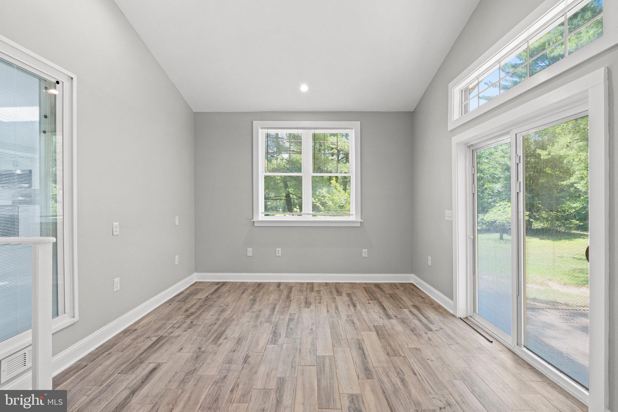 8405 Shirley Road Spotsylvania, VA 22551 - Photo 6 of 42 an empty room with wooden floor and windows