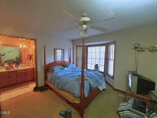 a bed room with a bed and a chandelier