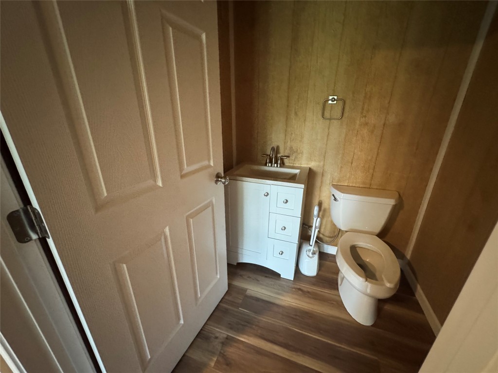 8060 County Road 210 Bertram, TX 78605 - Photo 33 of 40 Half Bathroom featuring vanity and dark wood-style floors