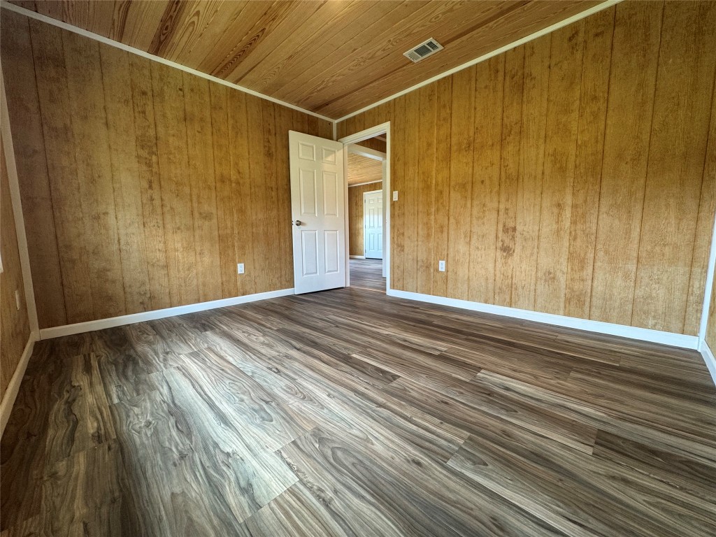 8060 County Road 210 Bertram, TX 78605 - Photo 35 of 40 Bedroom #1 featuring dark wood-style floors, wooden ceiling, and wood walls