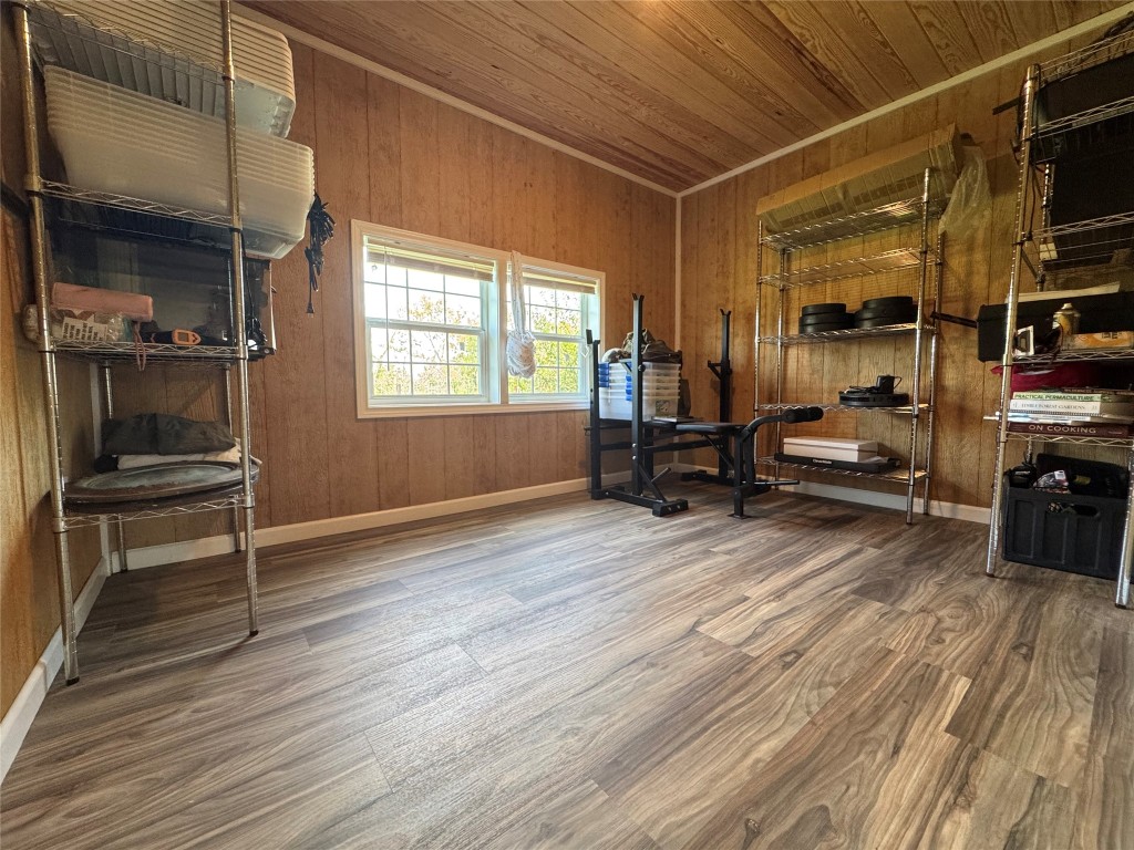 8060 County Road 210 Bertram, TX 78605 - Photo 36 of 40 Bedroom #2featuring dark wood-style floors, wooden ceiling, and wood walls