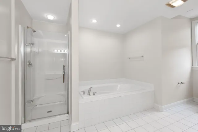 a bathroom with a bathtub and a shower
