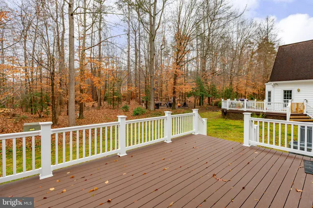 a view of a house with wooden deck