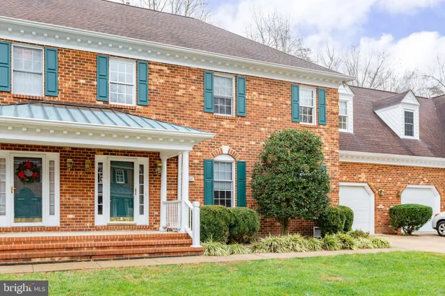 front view of a brick house with a yard