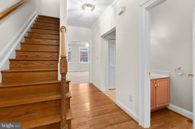 a view of a hallway with wooden floor and entryway