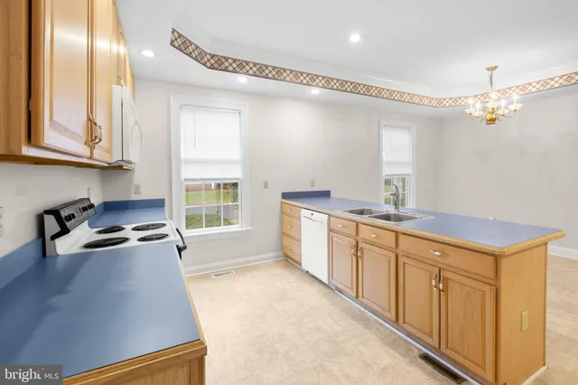 a kitchen with wooden cabinets and a sink