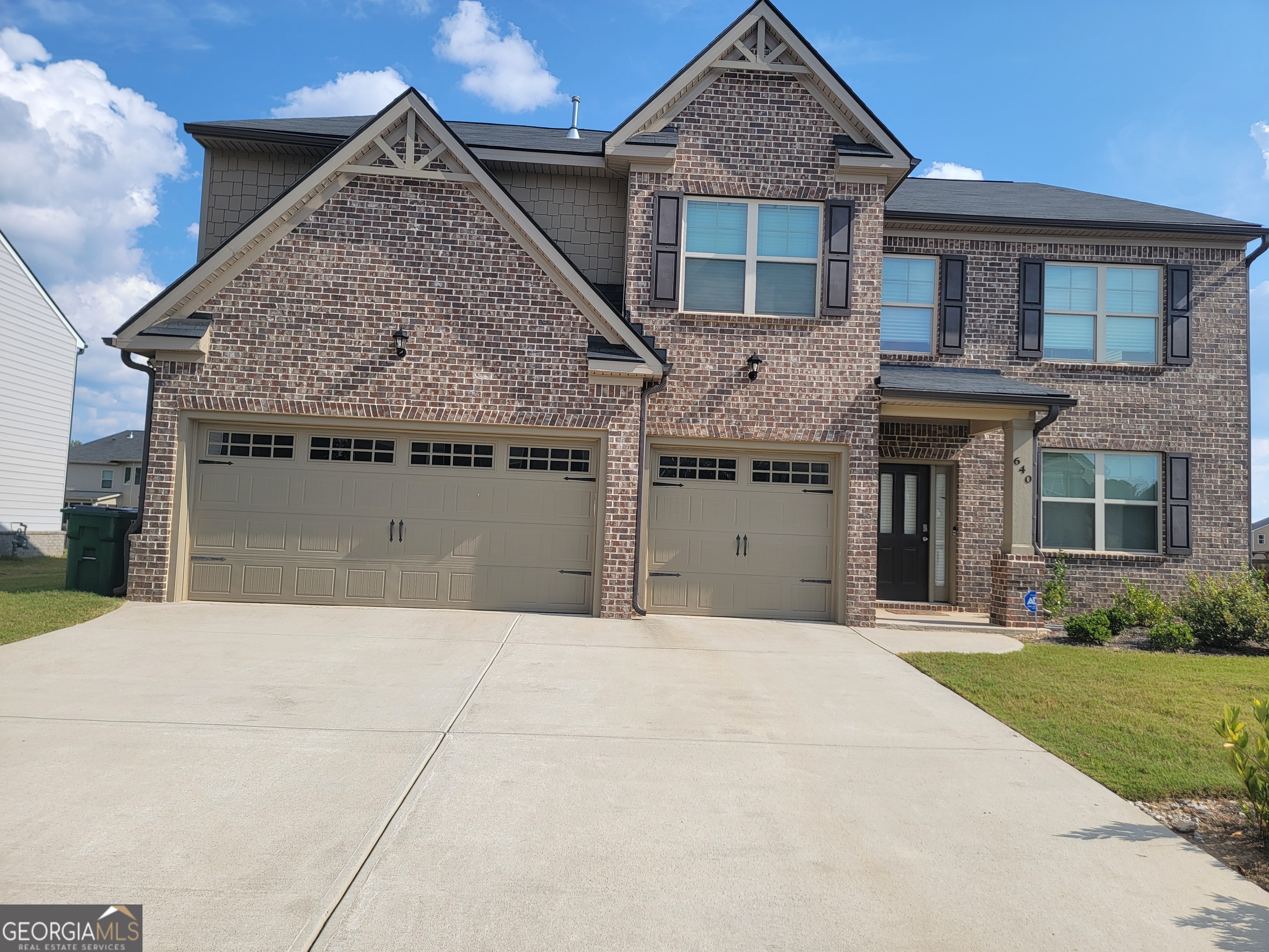 a view of a house with a garden and yard