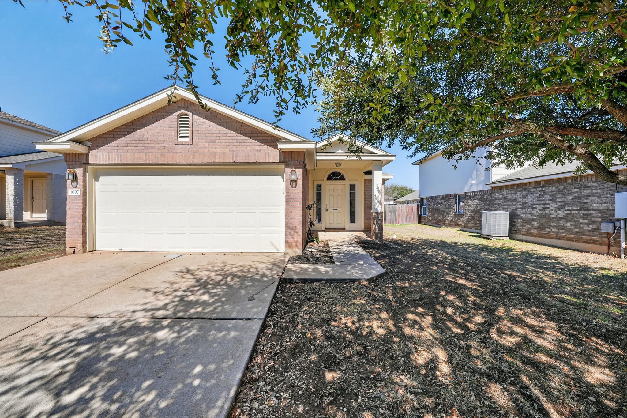 1007 Gentry Drive Leander, TX 78641 - Photo 2 of 35 a front view of a house with garden