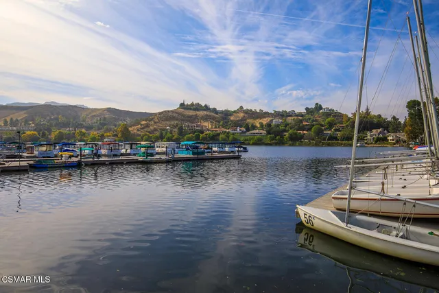 a view of a big yard with cars parked in front of it