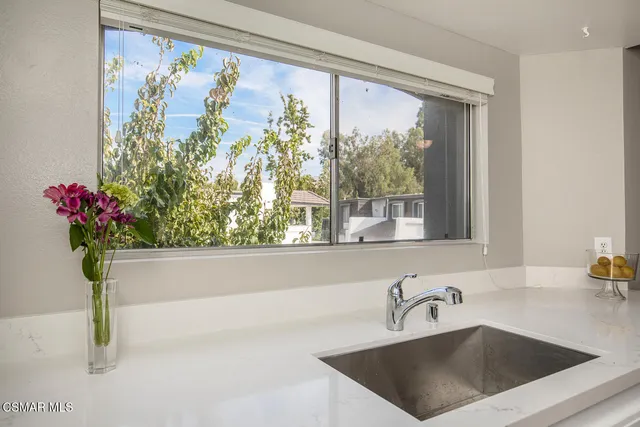 a kitchen with a refrigerator and a stove top oven