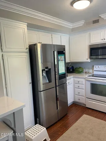 a kitchen with a stove a sink and a refrigerator