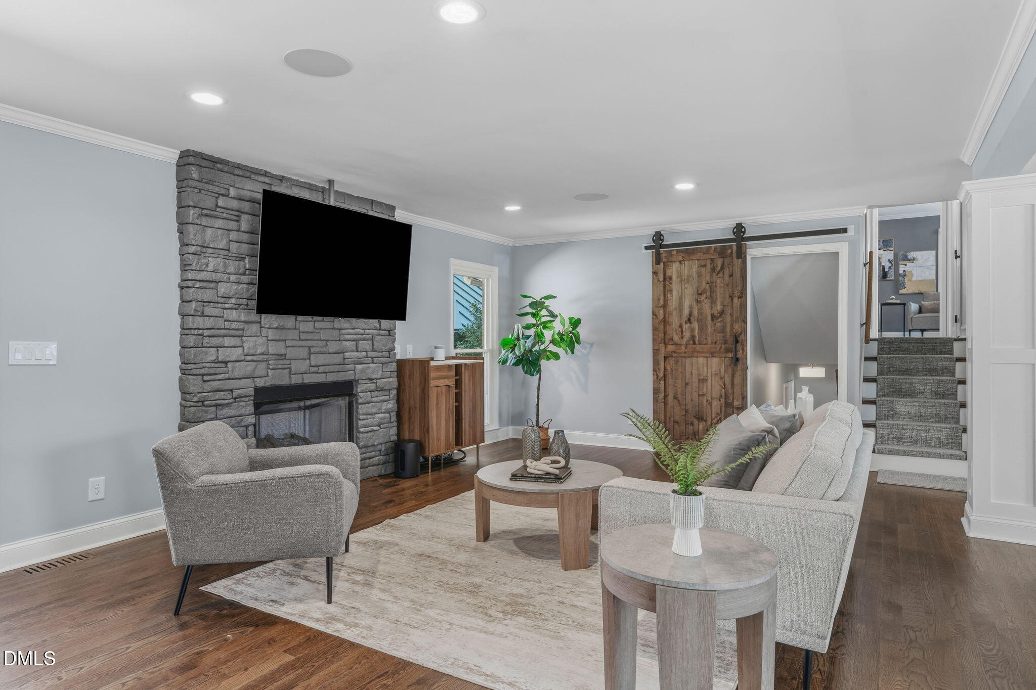 3016 Devonshire Drive Raleigh, NC 27607 - Photo 16 of 67 a living room with furniture a flat screen tv and a fireplace
