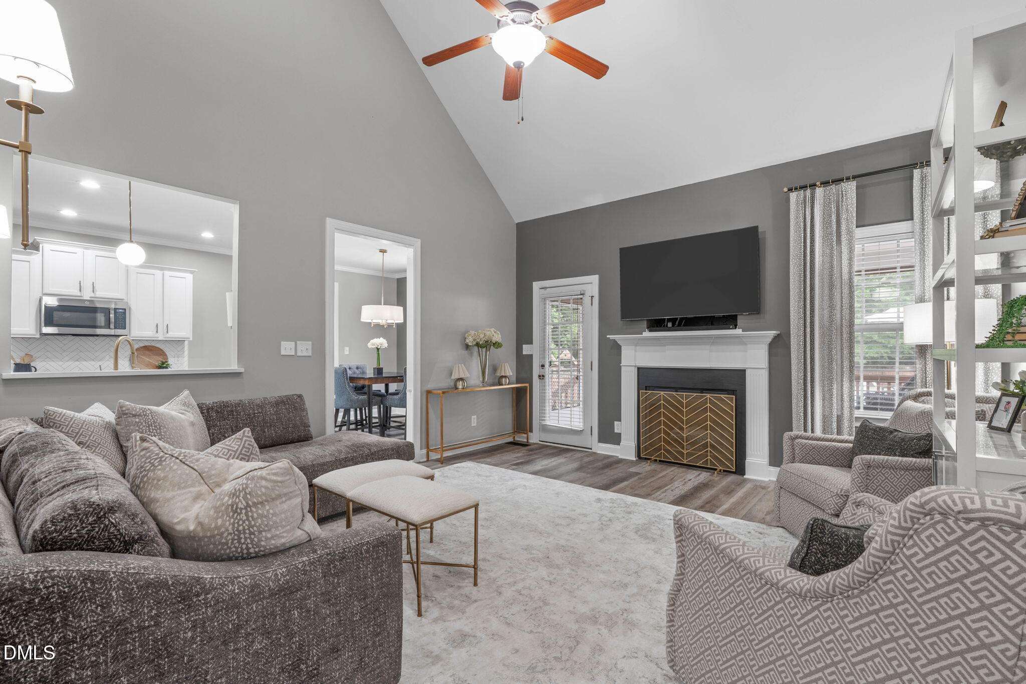 2450 Rolling Tracks Road Willow Spring, NC 27592 - Photo 12 of 64 a living room with furniture a fireplace and a flat screen tv