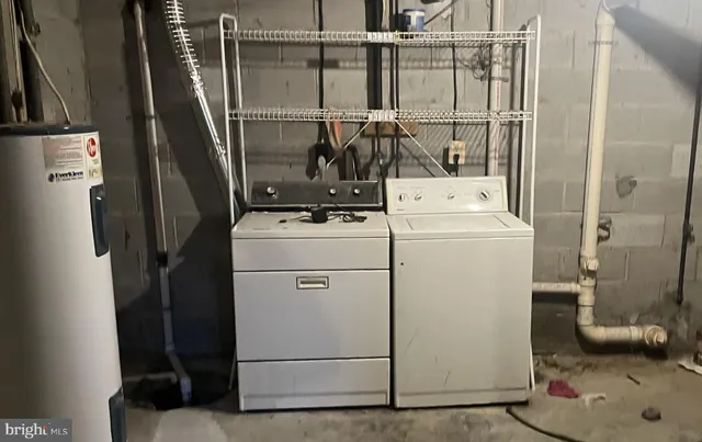 a view of storage and utility room with washer and dryer