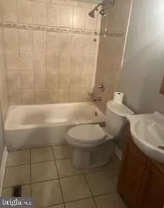 a bathroom with a toilet a sink and shower