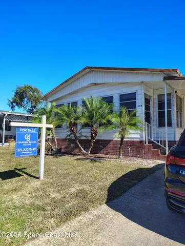 a view of a house with backyard porch and sitting area