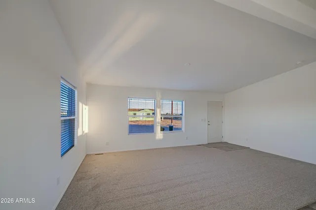 an empty room with windows and closet