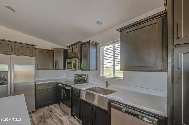 a kitchen with a sink stove and refrigerator