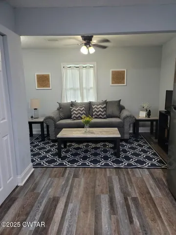 a living room with furniture and a rug