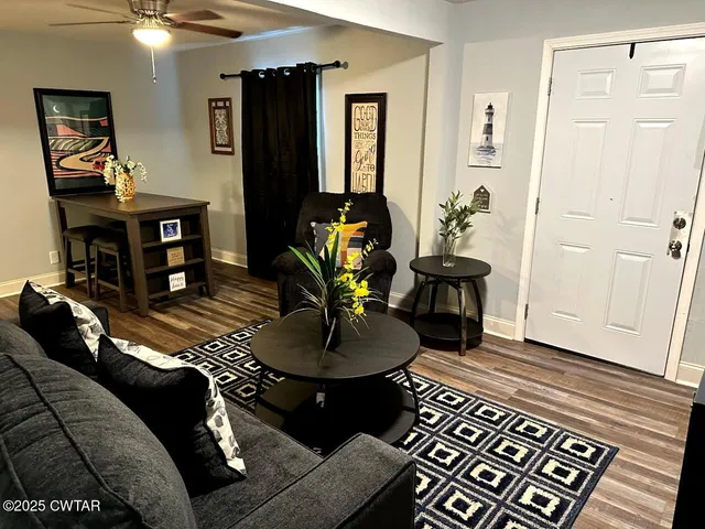 a living room with furniture and wooden floor