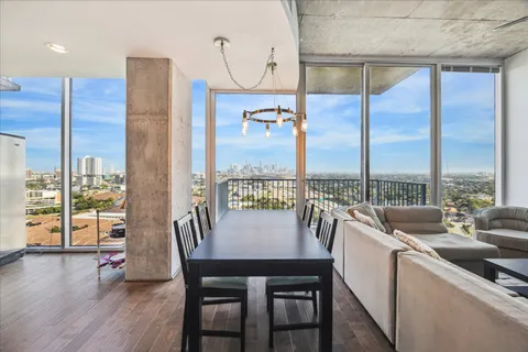 a view of a dining room with furniture window and wooden floor