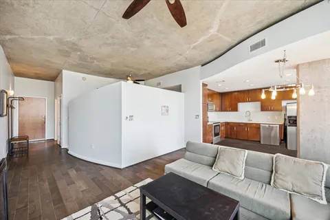 a living room with furniture and kitchen view