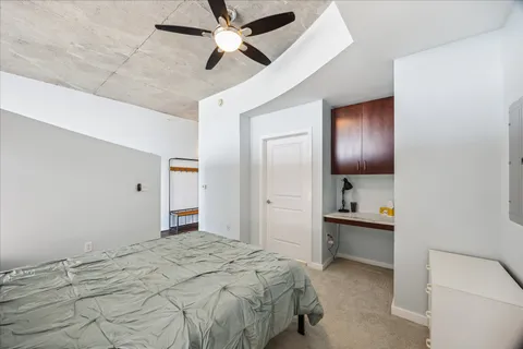 a bedroom with a bed and a chandelier
