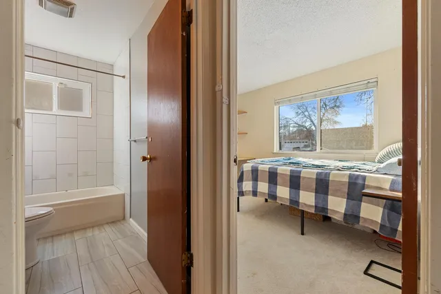 a bedroom with a bed and a window