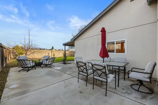 a view of a chairs and table in patio