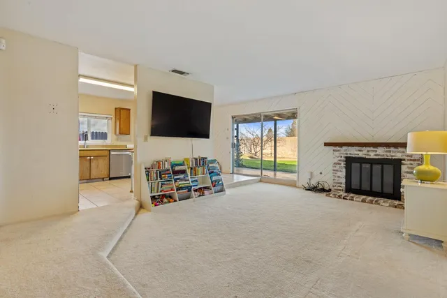 a view of a livingroom with furniture and a flat screen tv