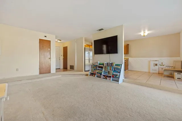 a view of a livingroom with furniture and a flat screen tv