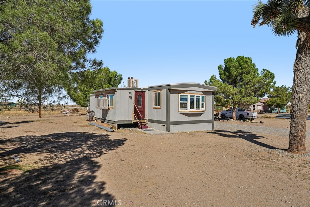 10444 Mono Road Victorville, CA 92392 - Photo 1 of 1 a view of a house with a tree in front