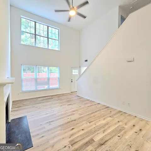 a view of empty room with wooden floor