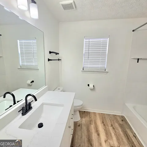 a bathroom with a sink a toilet and a bathtub