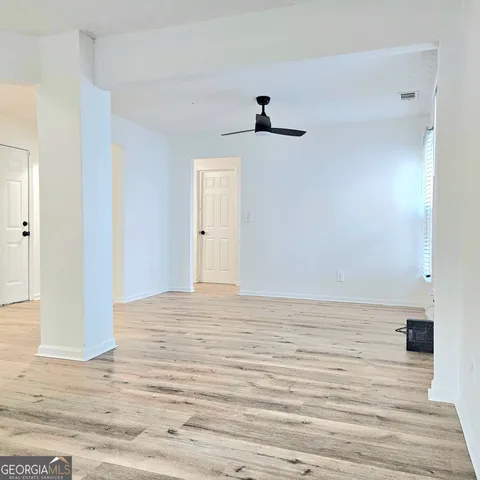 a kitchen with granite countertop a sink stove and cabinets