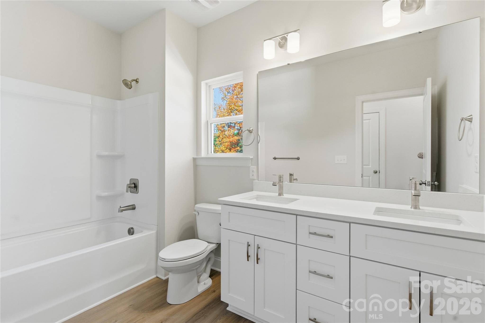 222 1st Street South Fort Mill, SC 29708 - Photo 15 of 23 a bathroom with a toilet a sink a tub and mirror