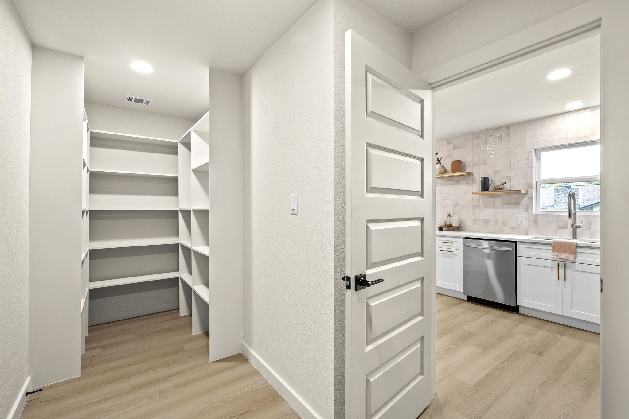 2107 Cindy Lane Austin, TX 78727 - Photo 16 of 33 Walk-in pantry featuring extensive built-in shelving, recessed lighting