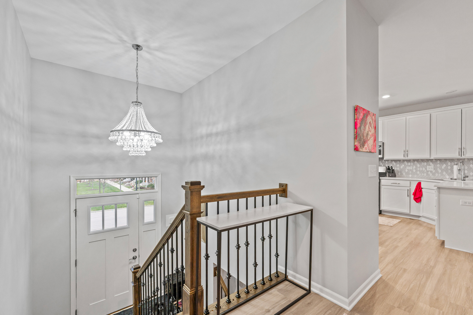 1627 Sager Way Batavia, IL 60510 - Photo 2 of 30 a view of a hallway with a chandelier