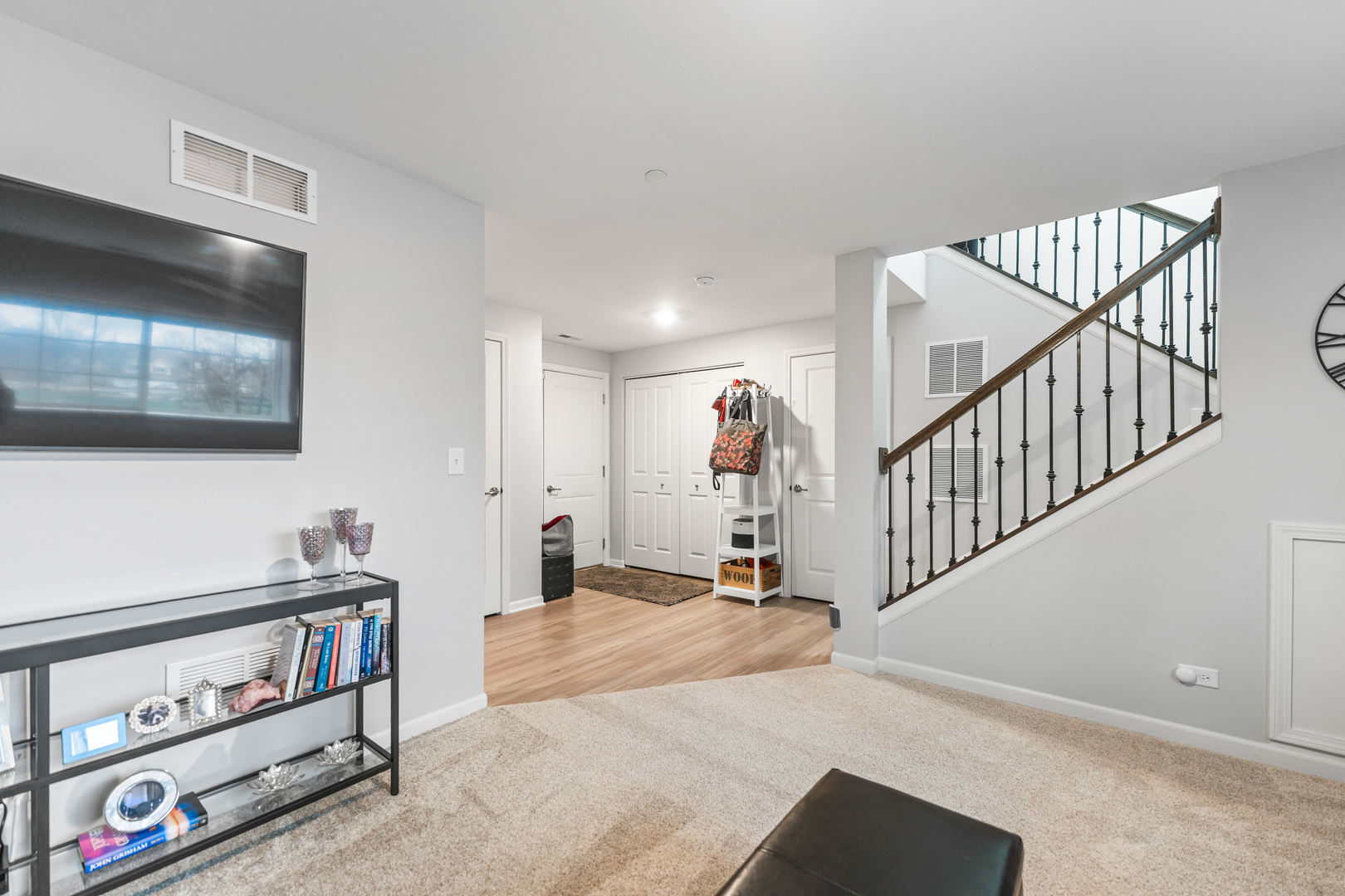 1627 Sager Way Batavia, IL 60510 - Photo 27 of 30 a view of staircase with lots of frames on wall and a flat screen tv