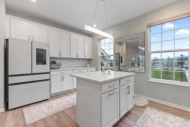 a kitchen with white cabinets appliances and sink