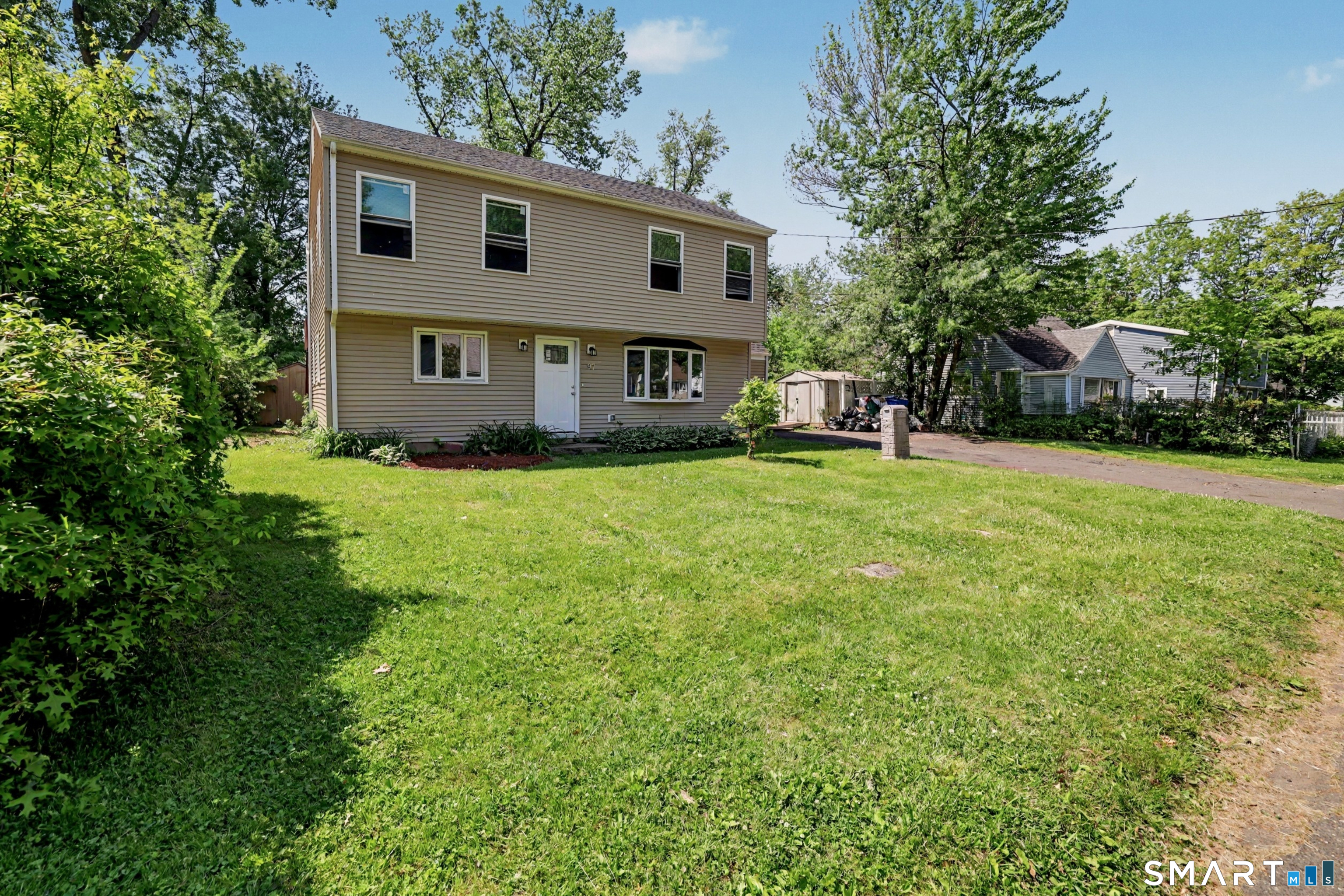 97 Boothbay Street Bloomfield, CT 06002 - Photo 3 of 33 a view of a house with a big yard