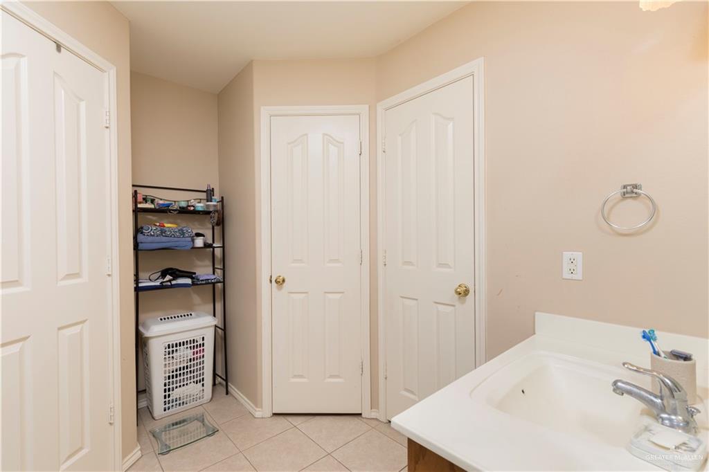 1801 Largo Street Weslaco, TX 78596 - Photo 15 of 20 a bathroom with a sink and a mirror